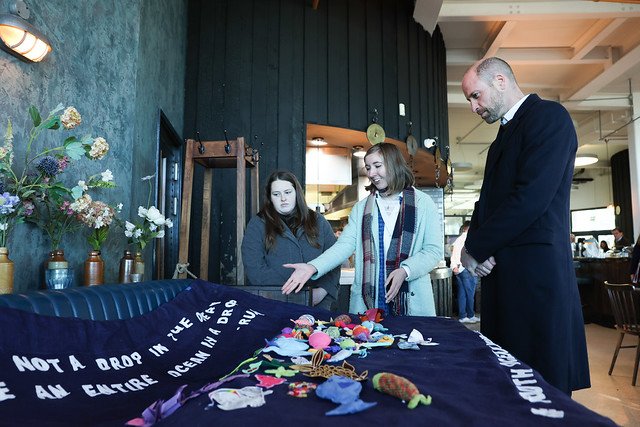 The Youth Ocean Network showing Prince William their beautiful artwork which reads 