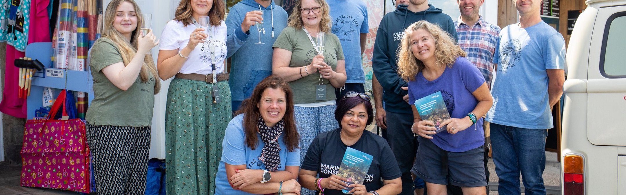 A group of Fatface employees standing outside their store