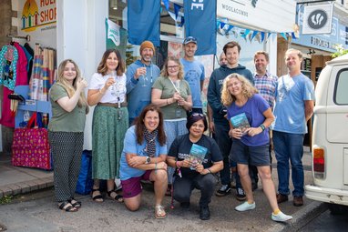 A group of Fatface employees standing outside their store