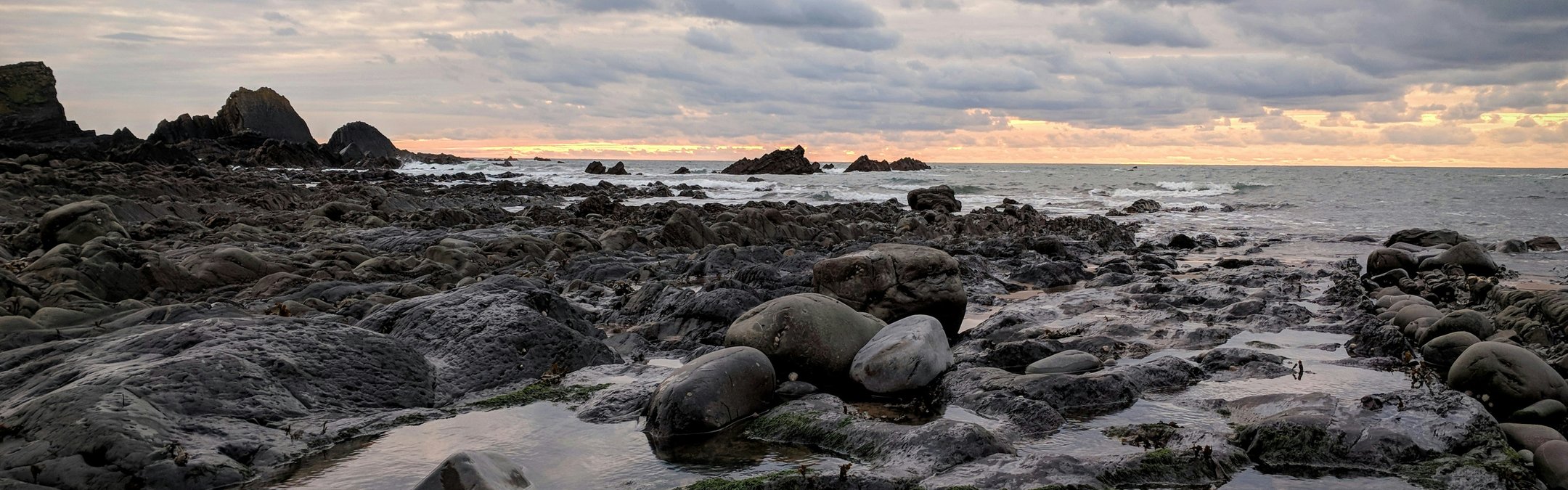 A sunset behind several rockpools