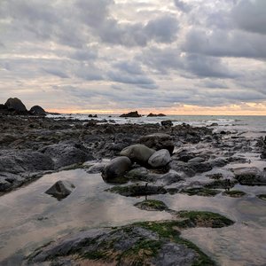 A sunset behind several rockpools