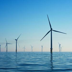 Wind turbines in water at Rampion Offshore Wind Farm, United Kingdom, with blue skies above the water