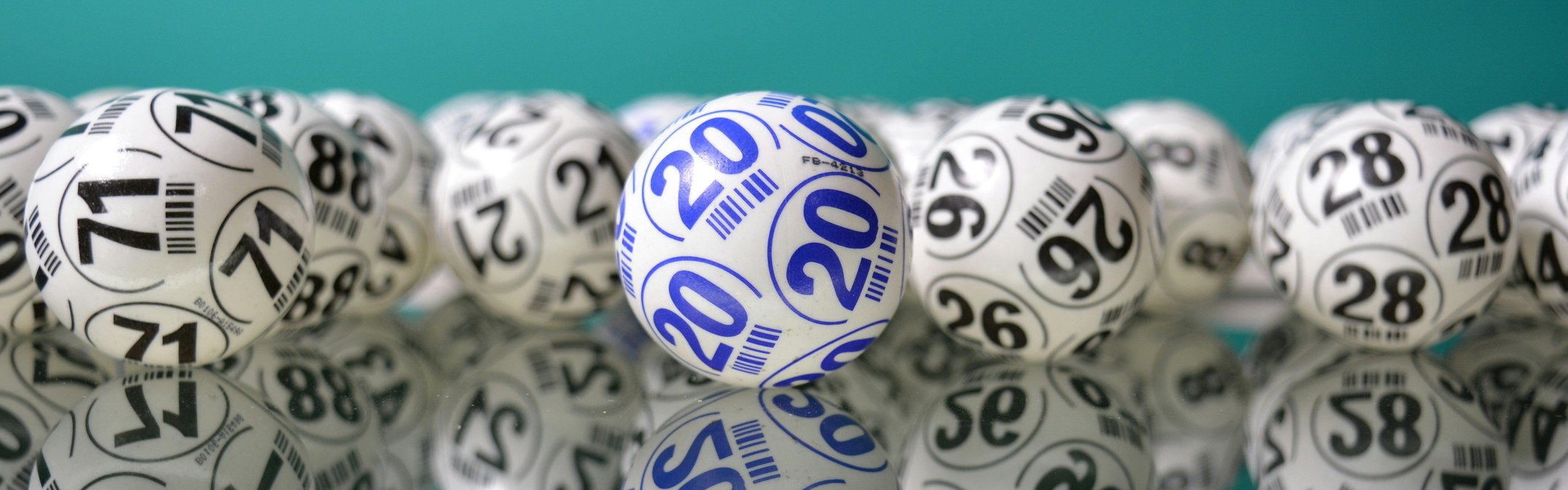 A line of lottery balls in front of a blue background