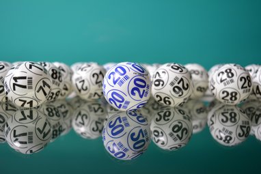 A line of lottery balls in front of a blue background