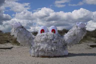 a large art installation named "Wallace," a monster created from wet wipes to highlight environmental pollution.