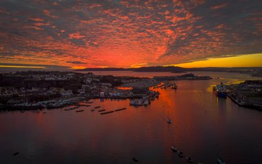 A camera shot of a sunset over th village of Oreston