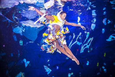 Marine Conservation Society Ambassador Fernando performs in a beautiful artistic display depicting the plastic pollution problem. He is underwater, surrounded by plastic and wears a costume made from colourful plastic. He is posed in a ballet position.