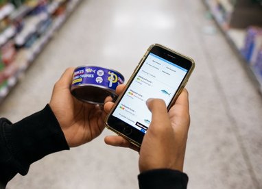 Using a smartphone to check the sustainability rating of a can of Tuna Chunks