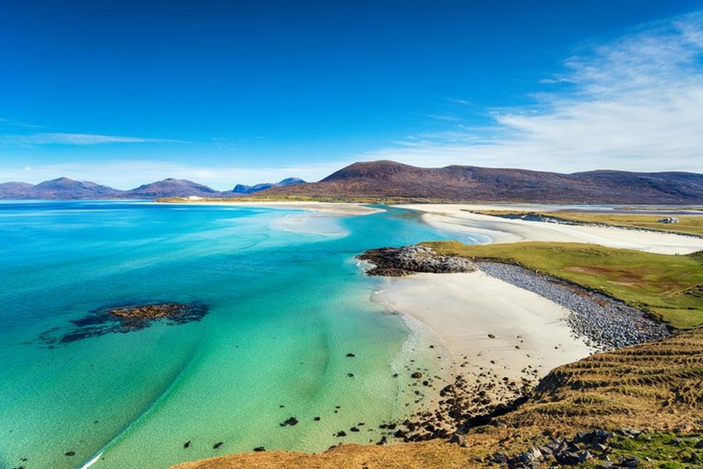 Seilebost beach on the Isle of Harris in the Outer Hebrides of Scotland - a sandy coast with a striking blue sea. The image is captured from an outcrop above the beach.